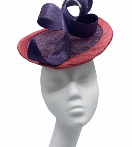 Purple and pink raw silk percher headpiece, it has a netting detail to the centre and raw silk swirls detailing to the front.