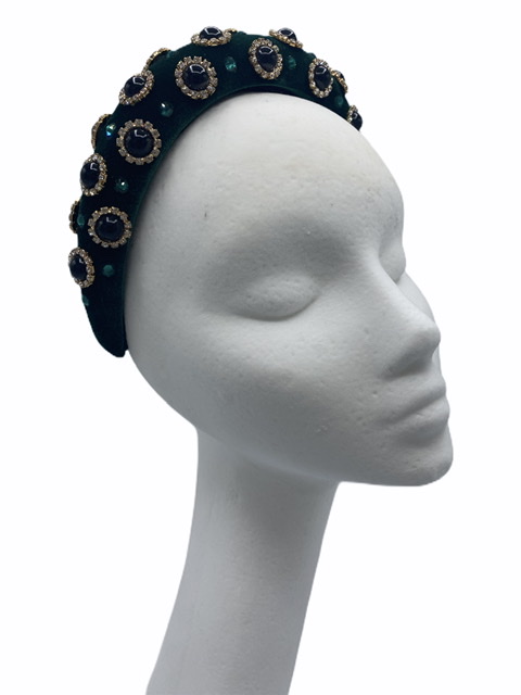 Green deep padded millinery made headband with black stone embellished detail throughout.