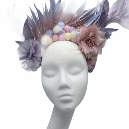 Multi-coloured pastel feather and pom pom crown, with flower detail.