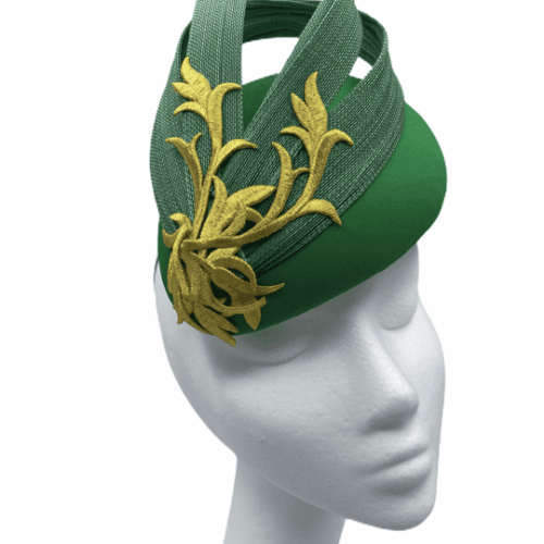 Green teardrop headpiece with yellow gold detail design to the swirl.