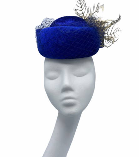 Royal blue velvet button pillbox with an ornate design, finished with an oversized bow to the back.