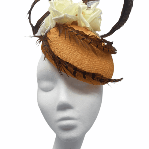 Orange headpiece with feather and ivory flower detail.