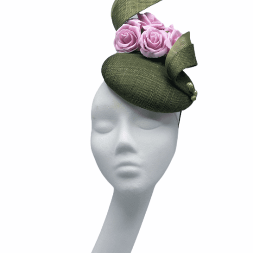 Green headpiece with swirl detail and finished with beautiful pink flowers.