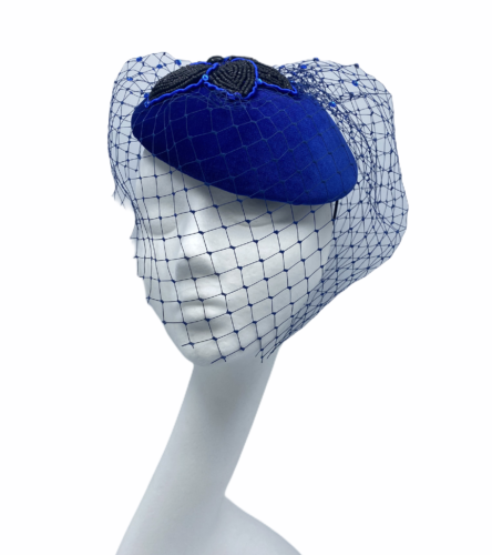 Cobalt velvet blue headpiece with black beaded flower detail finished with veiling detail that covers the face.