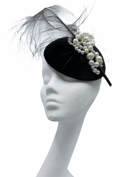 Black velvet headpiece with the most stunning pearl detail and large feather.