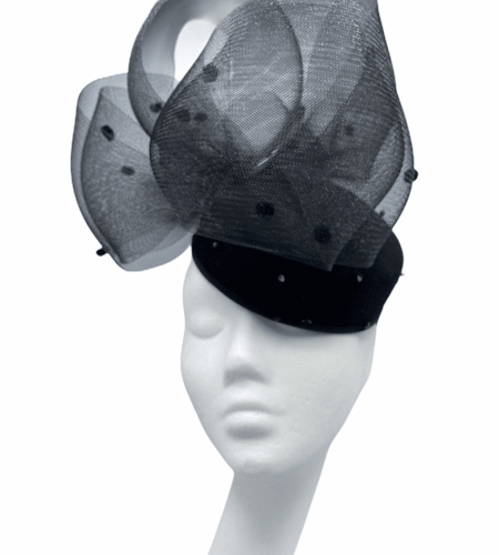 Black felt hat with black bead detail and polka dot detail to the top.