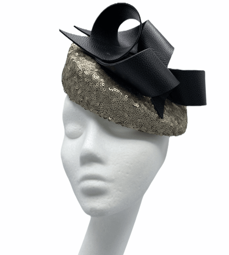 Gold sequinned shaped teardrop with black leather swirl detailing to the top.