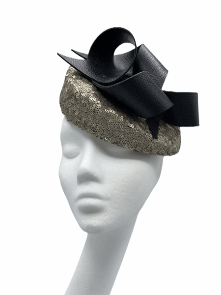 Gold sequinned shaped teardrop with black leather swirl detailing to the top.