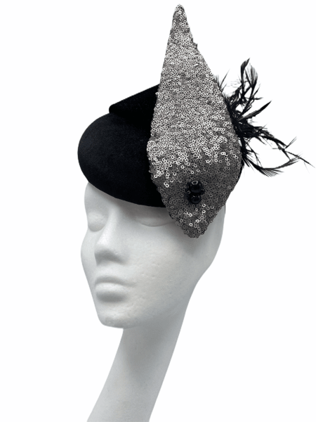 Black velvet pillbox with silver sequin structure detail to front, finished with black feather detail. 