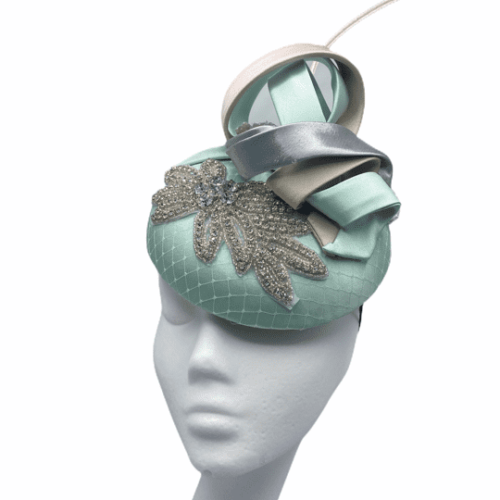 Mint green headpiece with diamanté detail finished with stunning pastel pink and pastel light lavender swirl detail.