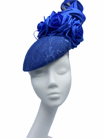 Large blue headpiece with blue foam swirl embellished detail to the top.