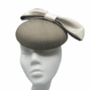 Taupe/beige coloured raw silk headpiece with beige/gold bow detail.