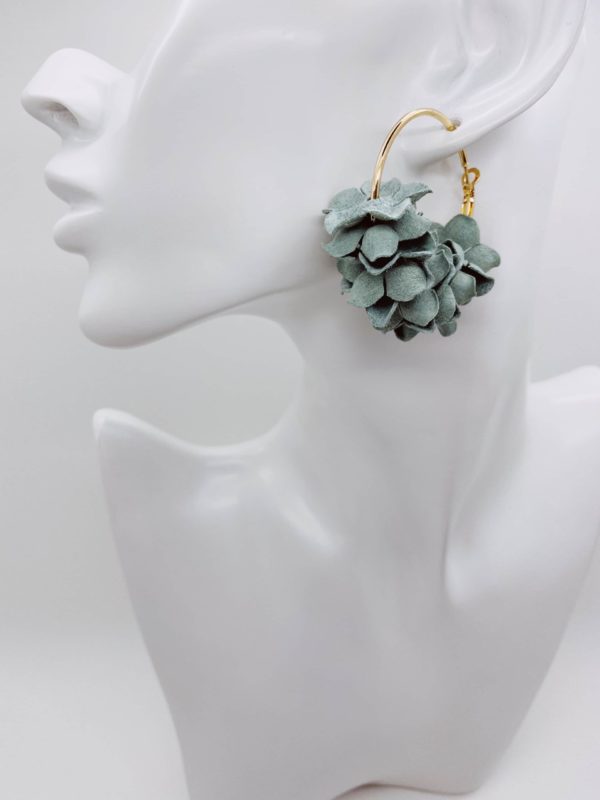 Gold hoop earrings with mint flower detail.