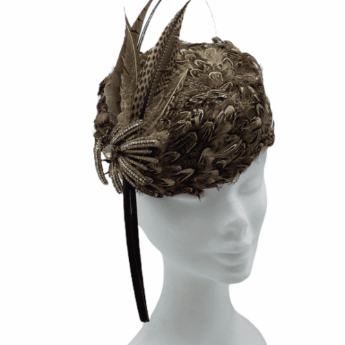 Feather encrusted headpiece with vintage brooch detail finished with beatiful feather and quill detail.