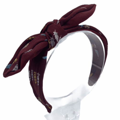 Burgundy headband with beautiful bow detail and finished with a subtle leaf detail. 