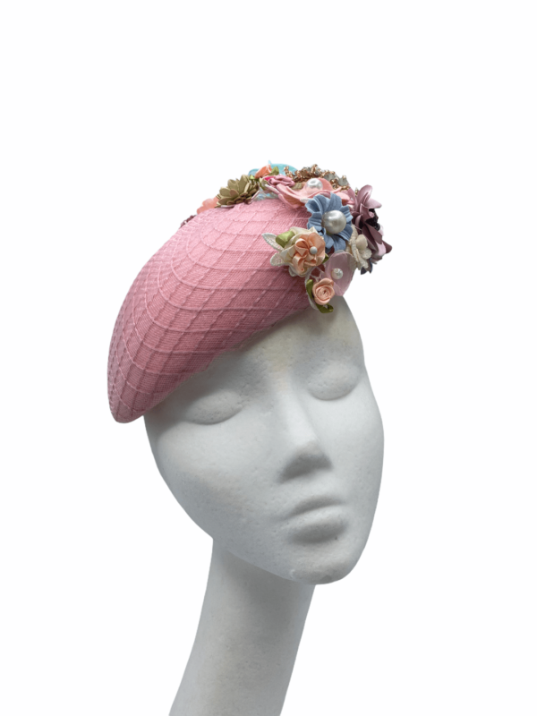 Pink teardrop headpiece with an array of coloured detail to rear of the headpiece.