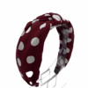 Burgundy headband with white polka dots.