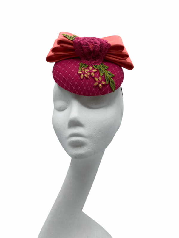 Pink small base headpiece with green & pink rose embellished detail and finished with coral top flat bow.