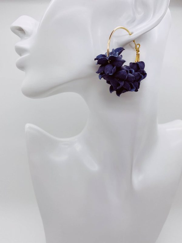 Gold hoop earrings with navy flower detail.