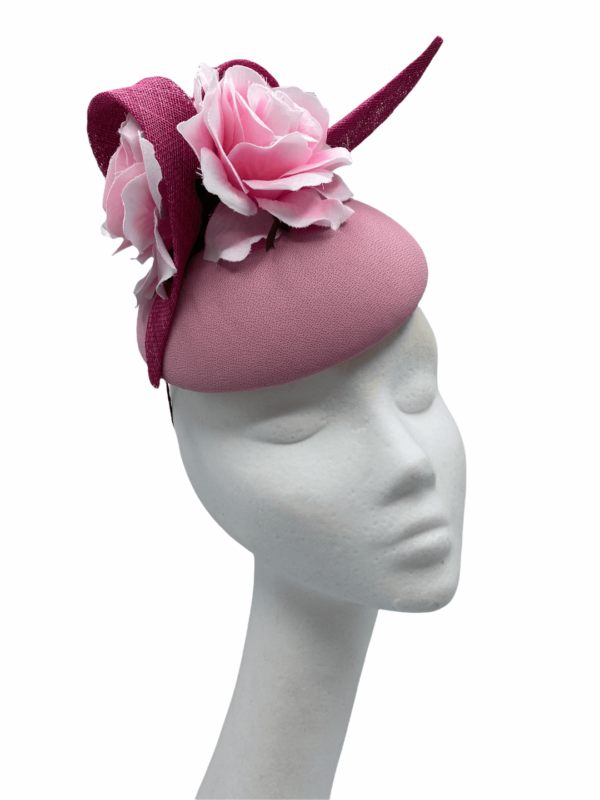 Baby pink base headpiece with baby pink flowers to the top and finished with darker pink swirl detail.