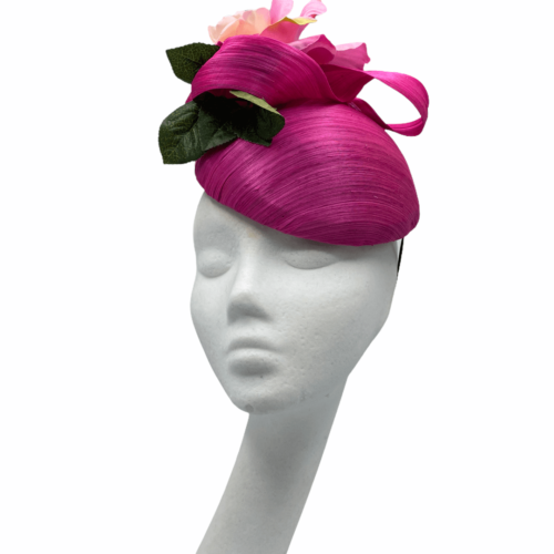 Pink raw silk headpiece with flower detail to top and finished with green leaf.