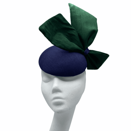 Stunning navy raw silk base headpiece with a beautiful raw silk forest green side bow to finish.
