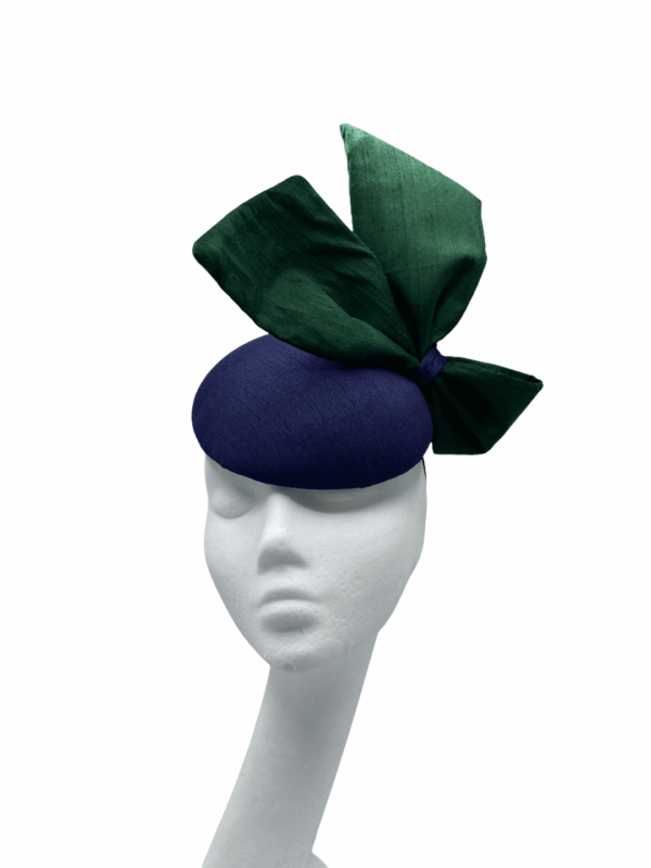Stunning navy raw silk base headpiece with a beautiful raw silk forest green side bow to finish.