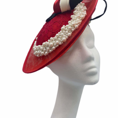 Red side saucer headpiece with pearl encrusted trim and finished with ivory/black and red swirl detail.