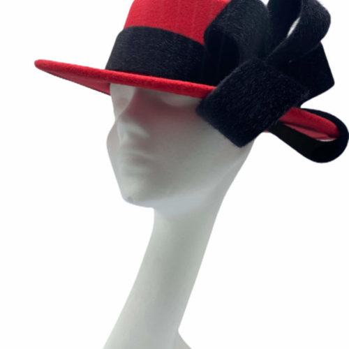 Red and black trilby millinery made headpiece.