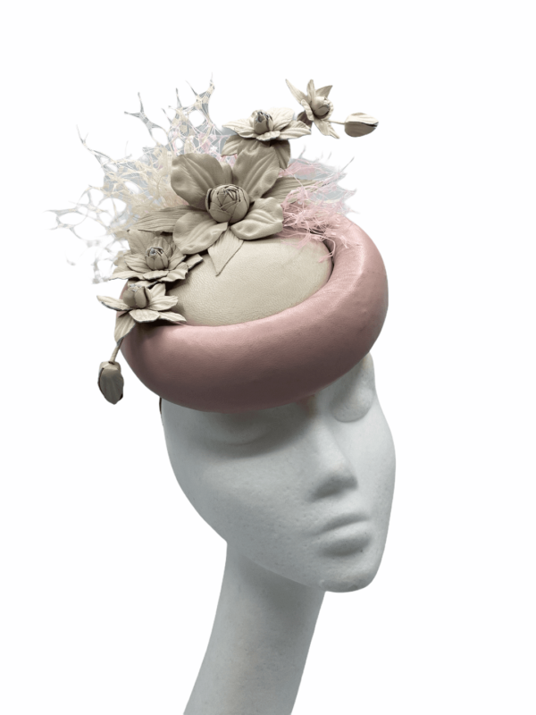 Pink/cream leather base with leather ivory handmade flowers, finished with a slight pink/cream netting detail. 