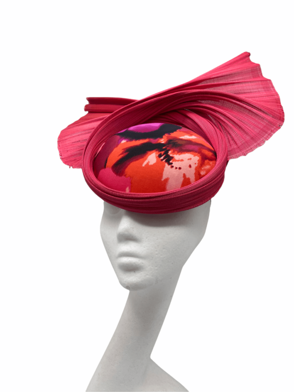 Pink fan details style headpiece with pink jinsin fan, to the centre of the headpiece are the following colours. coral, pink, orange and black.