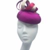 Stunning magenta headpiece with ivory swirl and pearl detail.