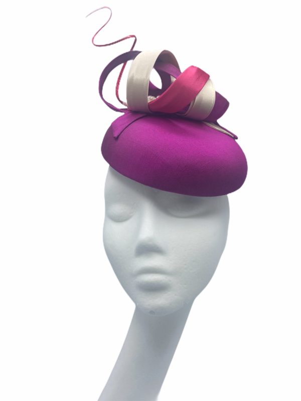 Stunning magenta headpiece with ivory swirl and pearl detail.
