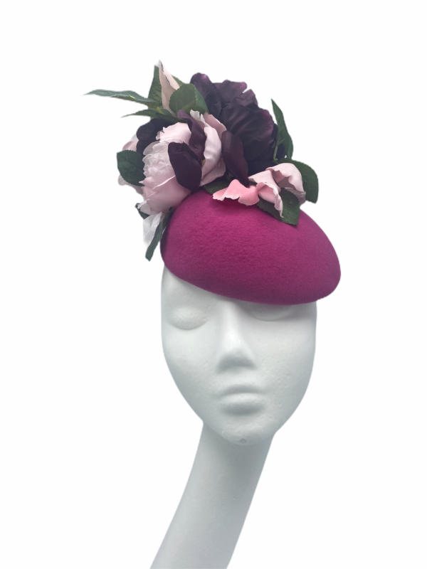 Magenta pink felt headpiece with pink/burgundy flowers and green leaf detail to finish.