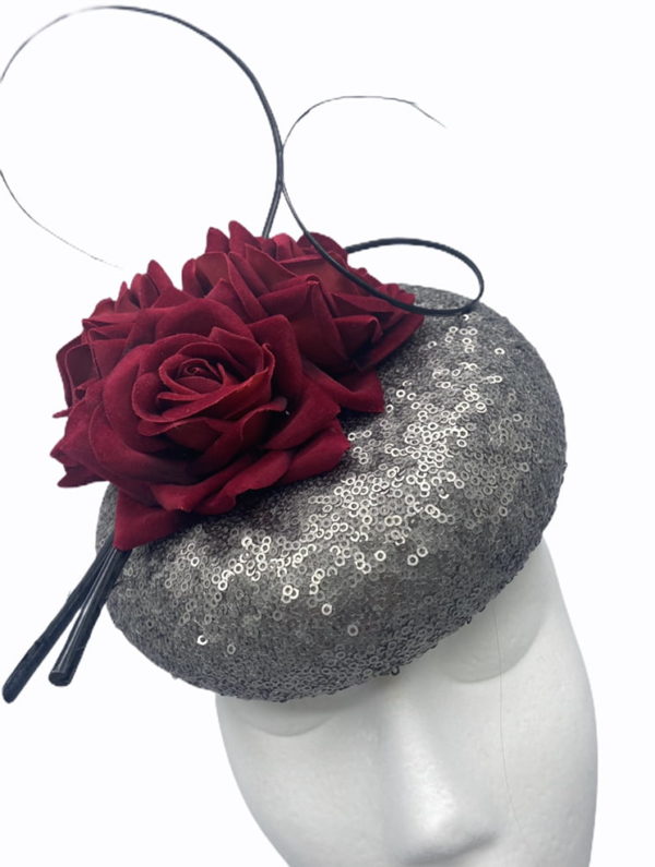 Pewter sequinned pillbox with stunning burgundy flower detail,  finished with black quill swirl detail.