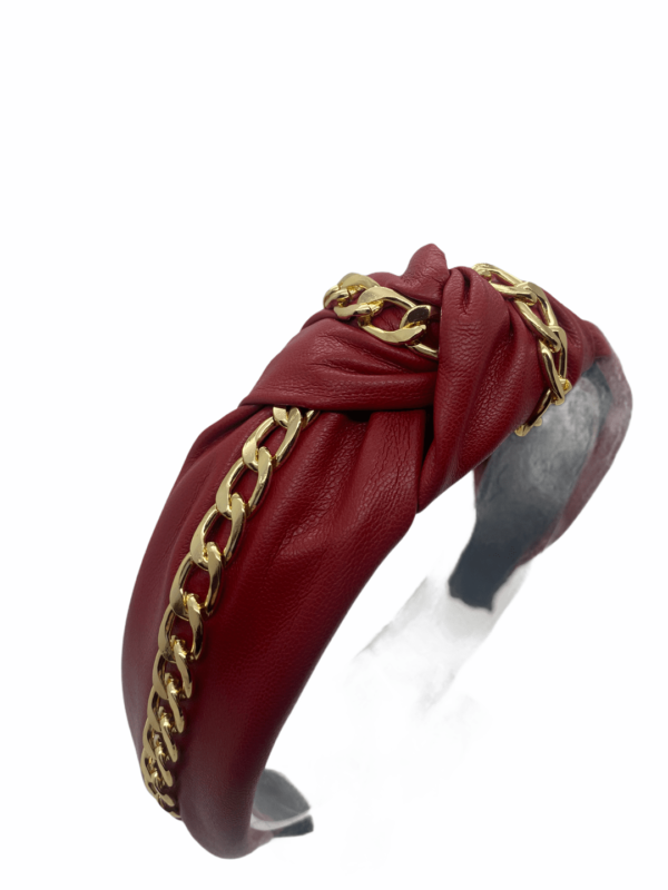 Burgundy faux leather headband with gold chain detail.