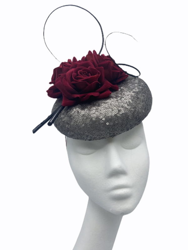 Pewter sequinned pillbox with stunning burgundy flower detail,  finished with black quill swirl detail.