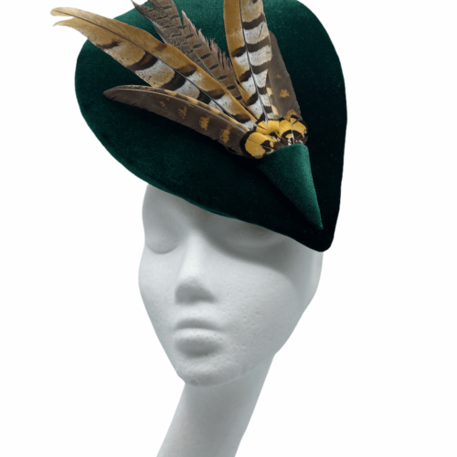 Stunning forest green velvet  percher with dramatic feather detail, finished with a twist to the back of the headpiece.