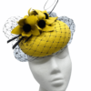 Yellow headpiece with black veiling and black centre flower detail.