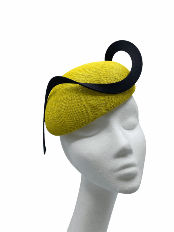 Yellow headpiece with structured swirl detail, small yellow pearl detail to the base of the swirl.