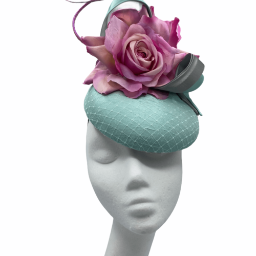 Stunning mint silk headpiece with pink flower detail.