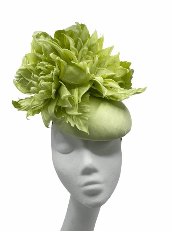 Light green satin headpiece with stunning dramatic flower detail.