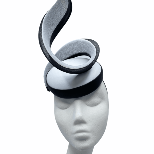 White leather headpiece with black trim detail and swirl structure to finish.