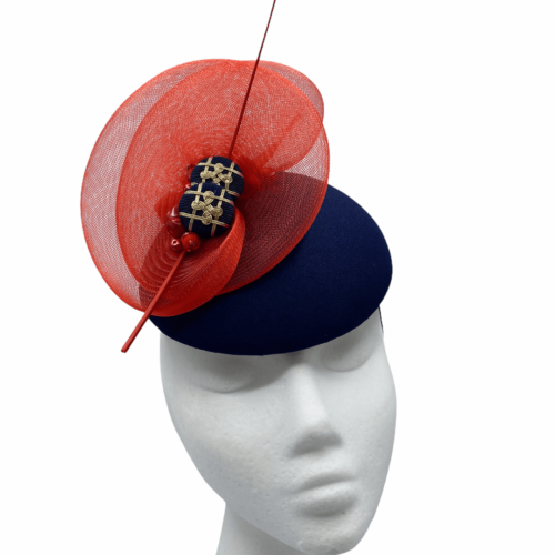 Stunning navy base headpiece with red crin detail, finished with stunning navy and gold buttons. 
