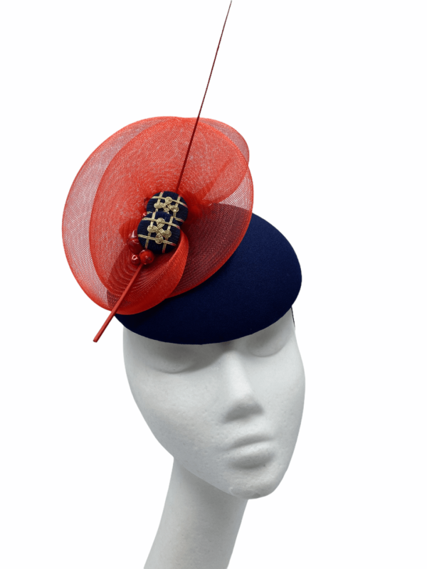 Stunning navy base headpiece with red crin detail, finished with stunning navy and gold buttons. 