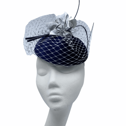 Navy headpiece with metallic silver veiling overlay with matching metallic flowers to finish.