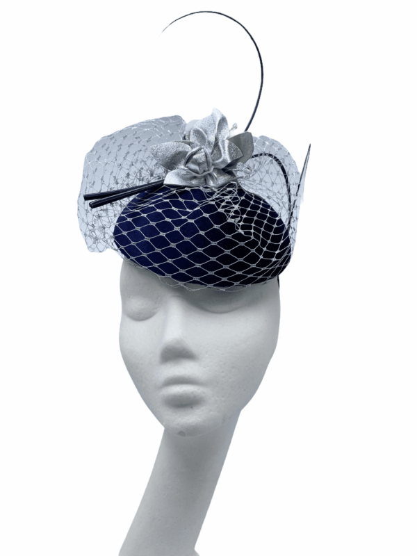 Navy headpiece with metallic silver veiling overlay with matching metallic flowers to finish.