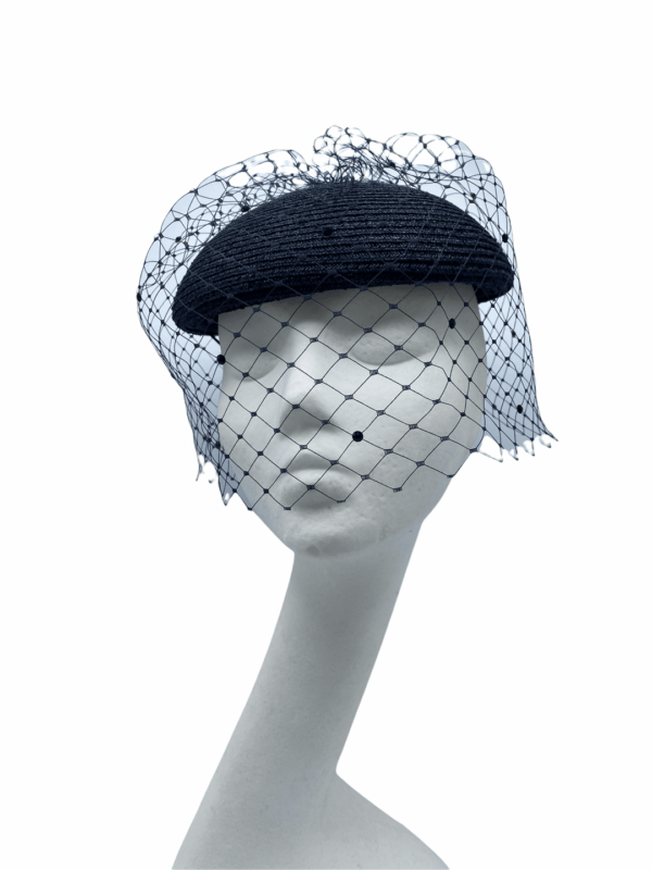 Stunning navy cap shaped base headpiece with stunning full face navy veiling.