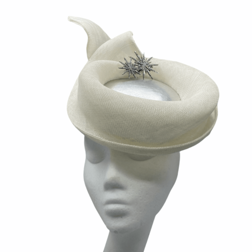Ivory percher headpiece with metallic silver centre and silver brooch detail.