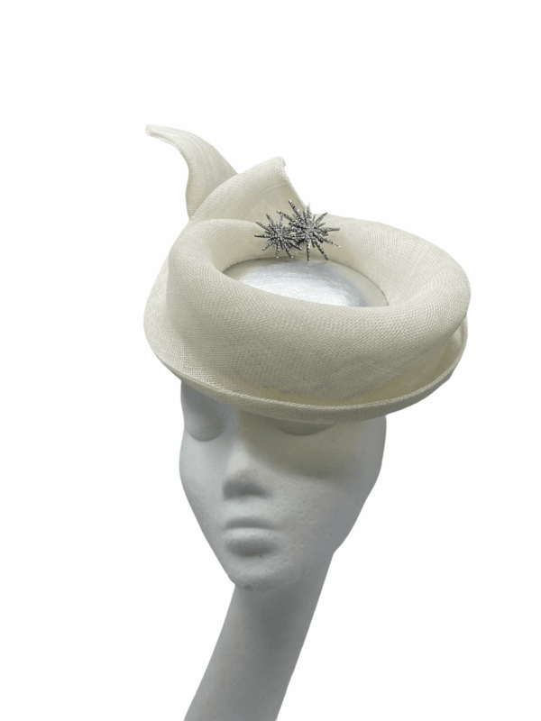 Ivory percher headpiece with metallic silver centre and silver brooch detail.